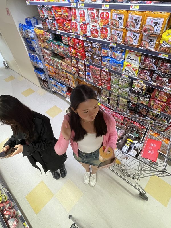 Anna and a friend with a shopping cart at H-mart
