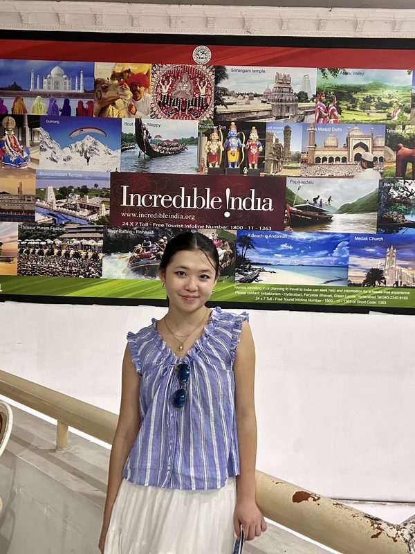 Anna standing in front of an Incredible India display